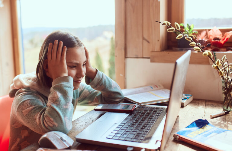 Schoolgirl does homework  at the home and looks worried