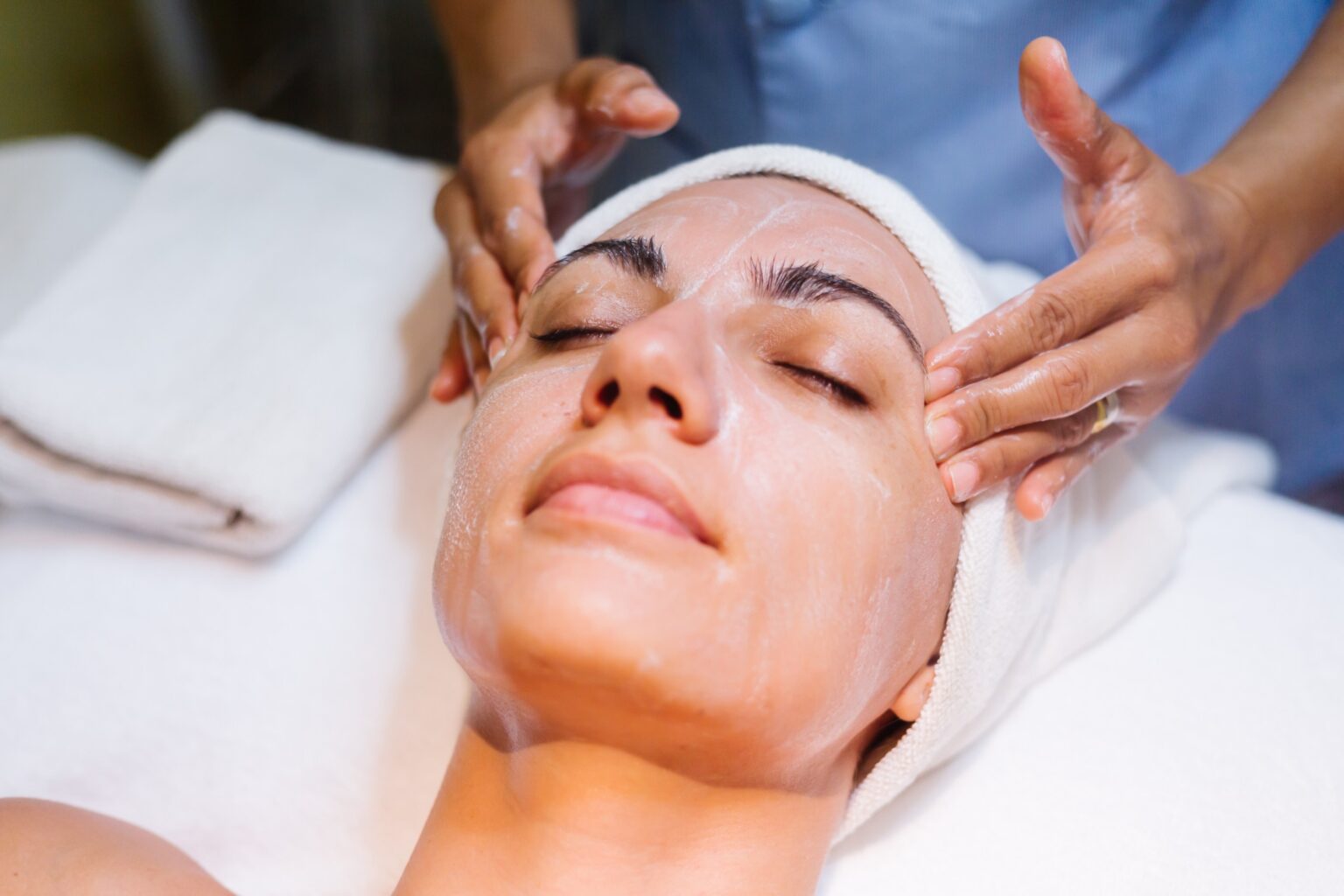 A woman enjoying relaxing facial treatment at a spa – professional Facial Services in Tysons Corner for glowing and rejuvenated skin.