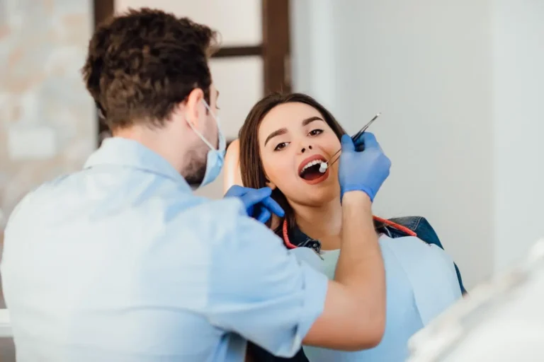 dentist-making-professional-teeth-cleaning-withb-cotton-female-young-patient-dental-office-2