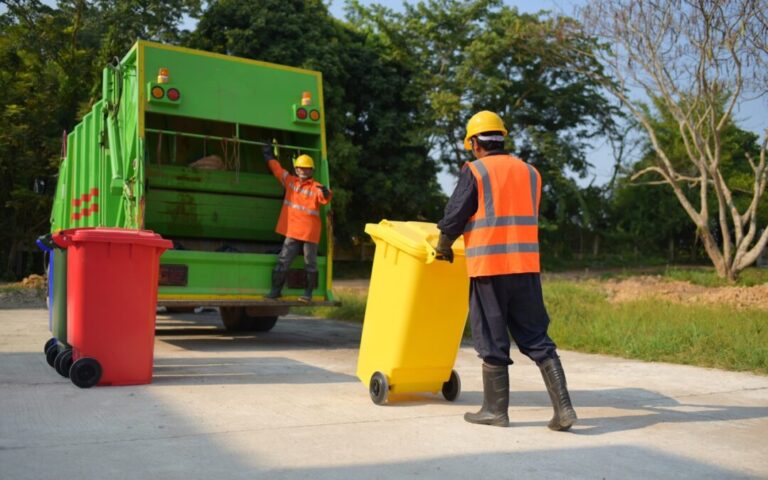 Garbage collector Worker of urban municipal recycling garbage collector truck loading waste and trash bin