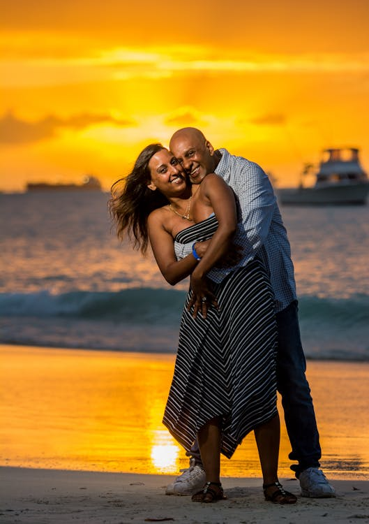Happy couple enjoying a romantic honeymoon on a Caribbean beach