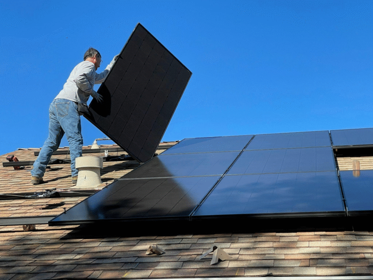 Technician installing solar panels on a residential rooftop