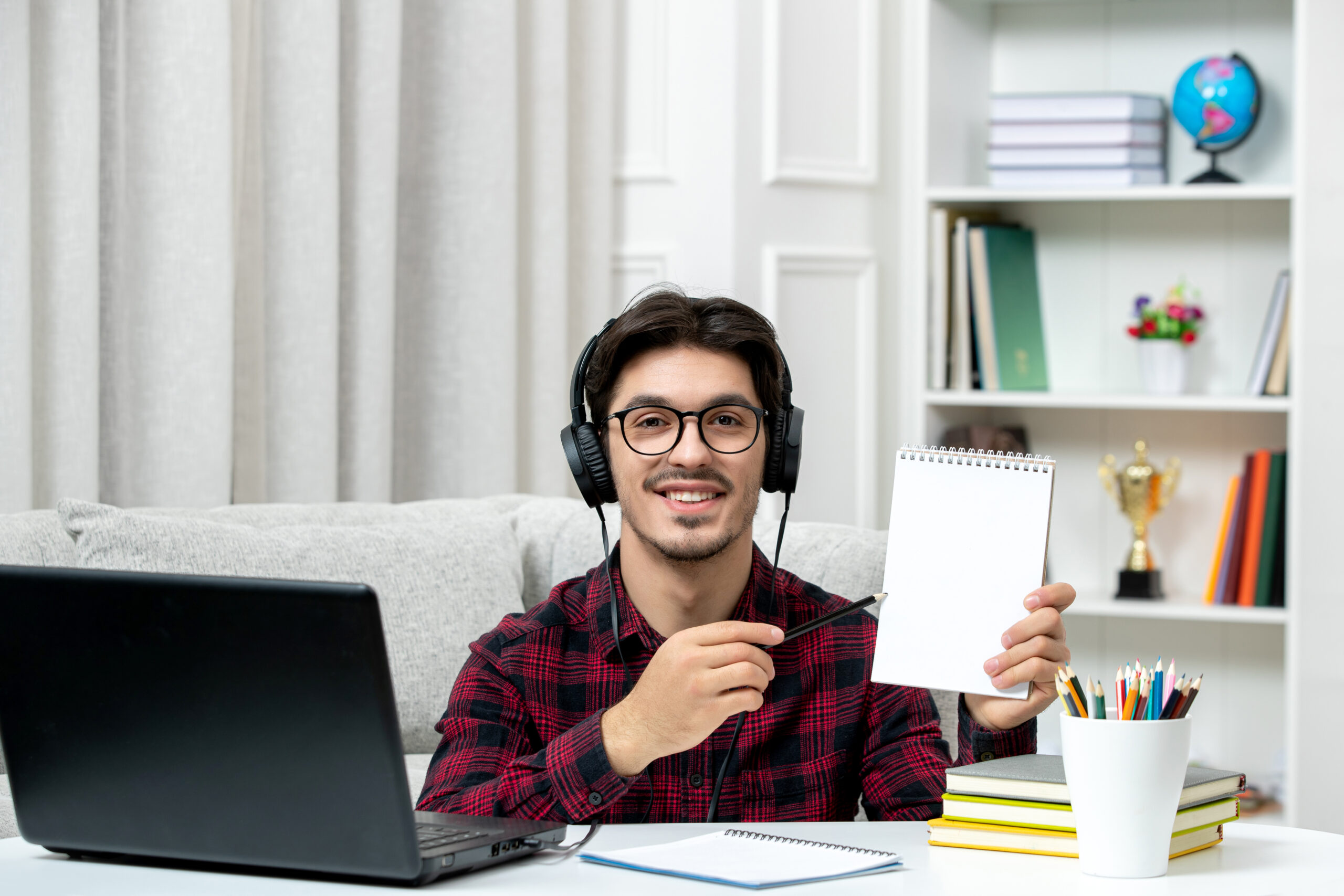student-online-cute-guy-checked-shirt-with-glasses-studying-computer-smiling-holding-notes
