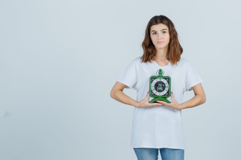 young-female-holding-clock-white-t-shirt-jeans-looking-sensible-front-view (1)