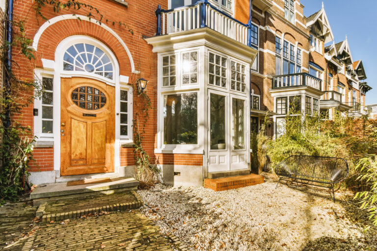 The facade of a brick building with wooden door