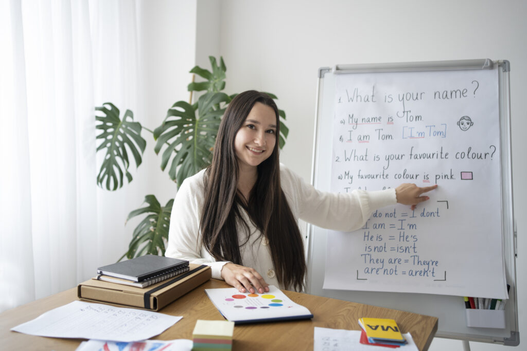 medium-shot-smiley-teacher-with-whiteboard-1024x683.jpg